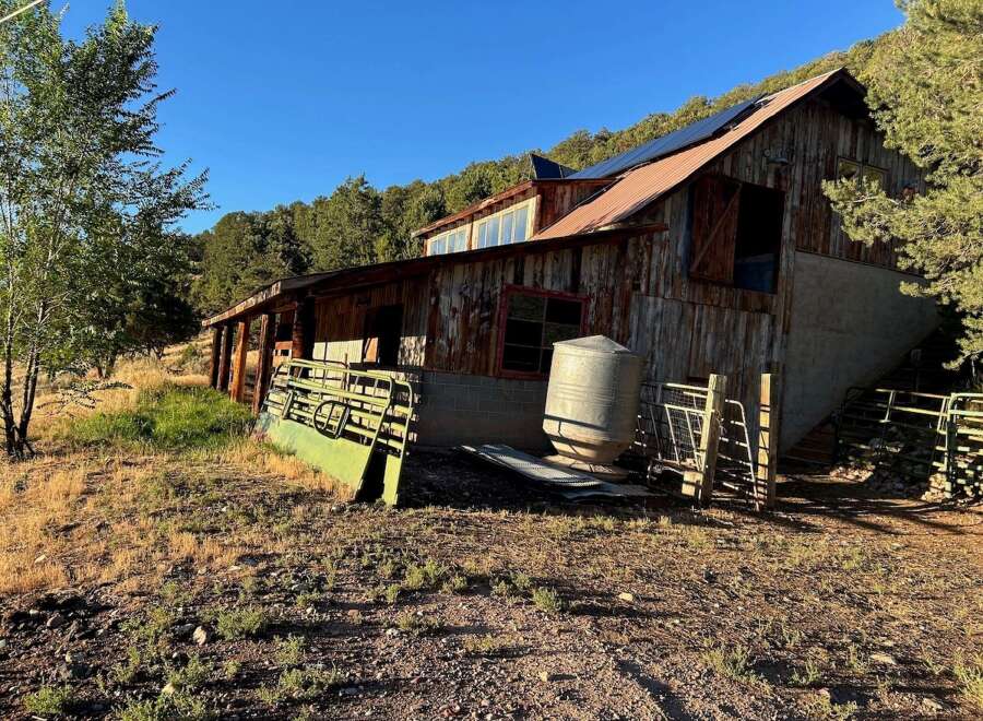 Discover this rustic barn with a unique architectural style, featuring a weathered wood exterior and a metal roof.