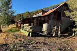 Discover this rustic barn with a unique architectural style, featuring a weathered wood exterior and a metal roof.
