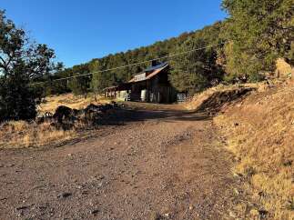 Discover this rustic barn nestled in a serene, wooded landscape, perfect for those seeking a peaceful retreat.