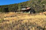Discover this rustic cabin nestled on a hillside, offering a unique blend of natural beauty and secluded living.