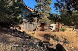 Discover this charming rustic barn nestled amongst mature pine trees, offering a unique blend of natural beauty and functional space.