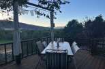 Enjoy breathtaking mountain views from this stunning deck, perfect for al fresco dining or morning coffee.