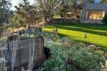 Discover a unique property with a charming backyard oasis, featuring a lush lawn perfect for relaxation and play.