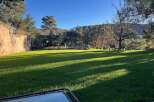 Enjoy the serene beauty of this property with a lush green lawn perfect for outdoor activities.