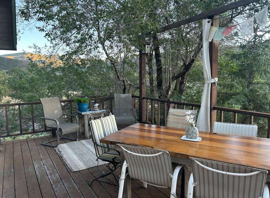 Enjoy breathtaking mountain views from this expansive deck, perfect for outdoor dining and relaxation.