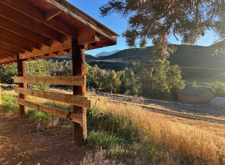 Discover this charming property featuring a rustic wooden shelter perfect for outdoor gatherings or equipment storage.