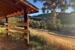 Discover this charming property featuring a rustic wooden shelter perfect for outdoor gatherings or equipment storage.