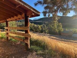 Discover this charming property featuring a rustic wooden shelter perfect for outdoor gatherings or equipment storage.