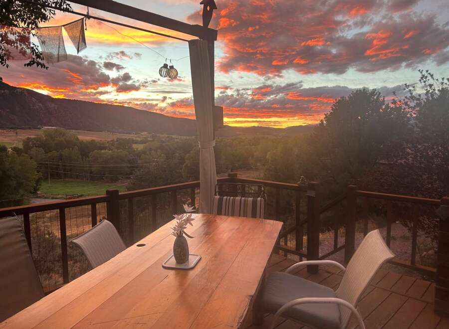 Experience breathtaking sunsets from this stunning deck, perfect for outdoor dining and relaxation.