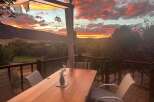 Experience breathtaking sunsets from this stunning deck, perfect for outdoor dining and relaxation.