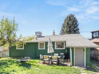 Enjoy outdoor living in this charming backyard! This property features a spacious lawn, perfect for gatherings.