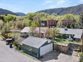 Nestled in a picturesque setting, this property boasts a charming garage with a basketball hoop, perfect for outdoor fun.
