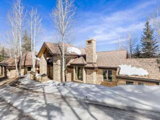 This stunning property boasts a beautiful stone exterior and a charming wooden roof, creating a warm and inviting atmosphere.