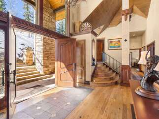 Step into luxury with this stunning property, showcasing a grand entrance with a beautiful wooden door.