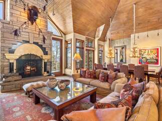 This stunning living room boasts a grand stone fireplace, perfect for cozy evenings.