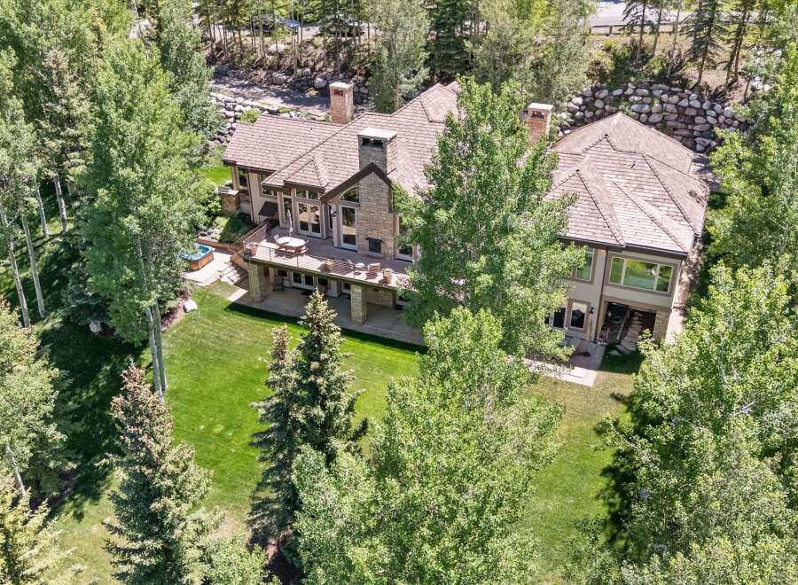 Experience luxury living in this stunning mountain home, nestled amidst lush greenery and mature trees.