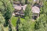 Experience luxury living in this stunning mountain home, nestled amidst lush greenery and mature trees.