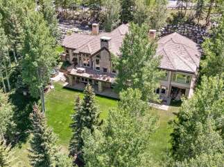 Experience luxury living in this stunning mountain home, nestled amidst lush greenery and mature trees.