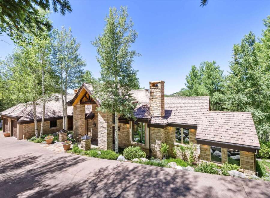 Experience luxury mountain living in this stunning stone-clad residence, nestled amongst mature aspen and pine trees.