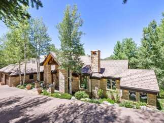 Experience luxury mountain living in this stunning stone-clad residence, nestled amongst mature aspen and pine trees.