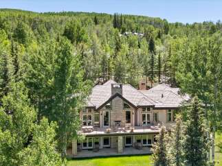 Nestled amidst a lush forest, this stunning mountain home offers a serene retreat with breathtaking natural beauty.