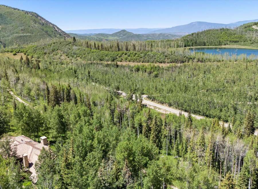 Nestled amidst a lush forest, this property offers a serene escape with breathtaking mountain views.