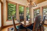 Experience elegant dining in this beautifully appointed room, featuring a rich mahogany table surrounded by plush leather chairs.