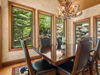 Experience elegant dining in this beautifully appointed room, featuring a rich mahogany table surrounded by plush leather chairs.