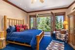 Experience rustic charm in this inviting bedroom, featuring a sturdy log bed and cozy plaid accents.
