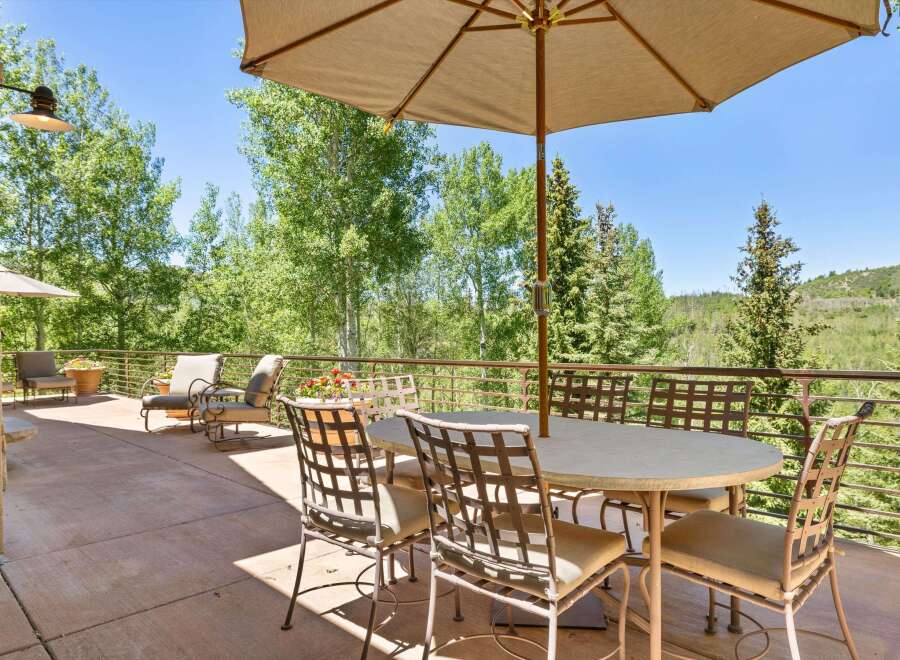 Enjoy al fresco dining on this spacious patio, complete with a large umbrella and comfortable seating for six.