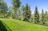 Enjoy the serene beauty of this property, featuring a lush, manicured lawn perfect for outdoor activities.