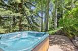 Indulge in ultimate relaxation with this luxurious hot tub, perfectly situated amidst a serene forest setting.