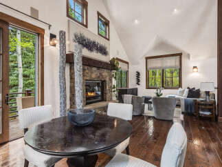 This stunning property boasts a cozy living room with a stone fireplace, perfect for relaxing evenings.