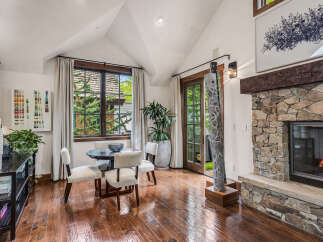 This stunning property boasts a cozy living space with a beautiful stone fireplace, perfect for relaxing evenings.