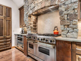 This stunning kitchen boasts a rustic yet modern design, perfect for culinary enthusiasts.