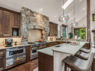 This stunning kitchen boasts a luxurious design with high-end appliances and custom cabinetry.