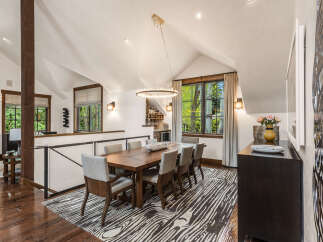 Step into luxury with this stunning dining room, featuring a beautiful wooden dining table and stylish chairs.