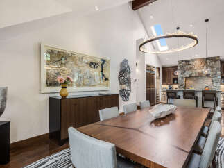 This stunning dining room showcases a blend of modern and rustic design elements, perfect for entertaining.