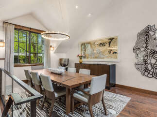 This stunning dining room showcases a modern aesthetic with its sleek design and elegant furnishings.