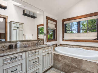 Step into luxury with this stunning bathroom featuring a spacious soaking tub and elegant vanity.