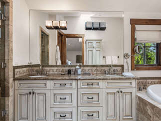 This luxurious bathroom boasts a stunning double vanity with ample storage and a beautiful marble countertop.