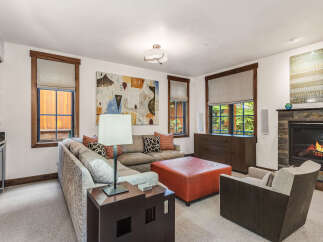 This stunning living room boasts a cozy fireplace, perfect for chilly evenings.