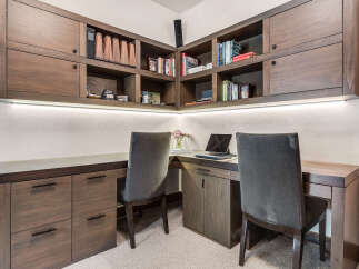 This stunning home office features custom built-in cabinetry, providing ample storage and a sleek, modern aesthetic.