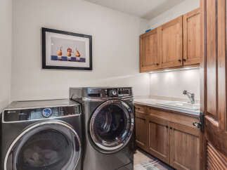This laundry room features a modern washer and dryer set, perfect for handling all your laundry needs.