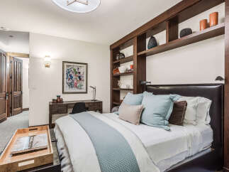 This luxurious bedroom showcases a blend of comfort and style, perfect for a relaxing retreat.