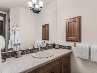 This stunning bathroom boasts a luxurious design with a beautiful vanity and ample storage.