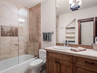 This stunning bathroom boasts a luxurious design with a beautiful vanity and a spacious shower.