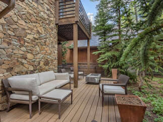 Enjoy outdoor living at its finest with this stunning property featuring a spacious deck and comfortable seating.
