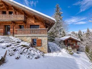 This stunning chalet-style property offers a luxurious retreat in a picturesque winter setting.