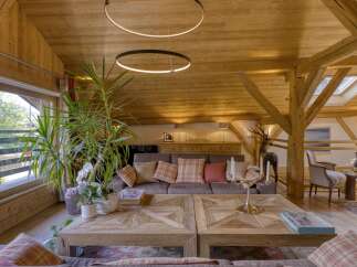 Experience the charm of this stunning property, featuring a cozy living room with a wooden ceiling and beams.
